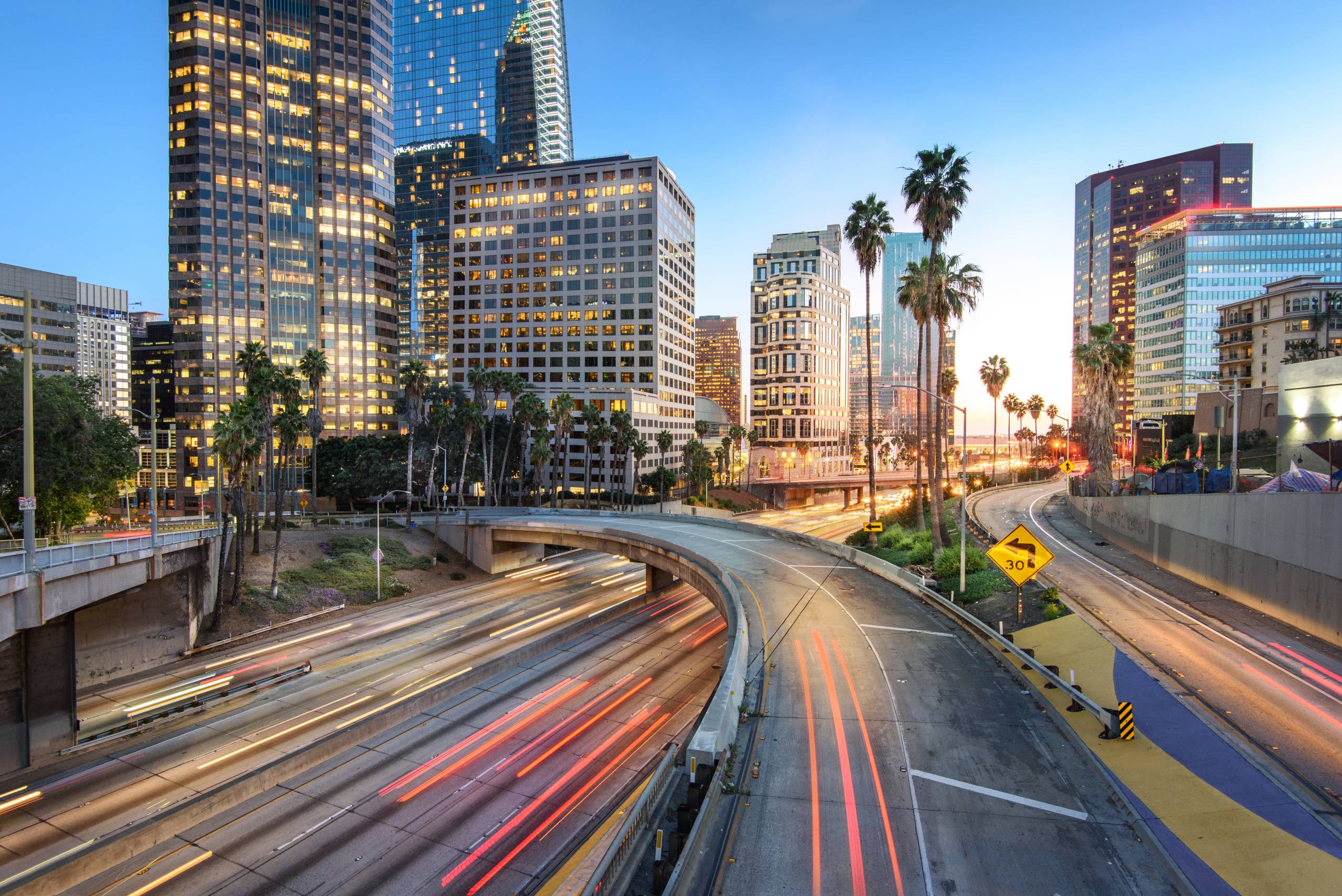 Downtown Los Angeles at sunset with car traffic light trails